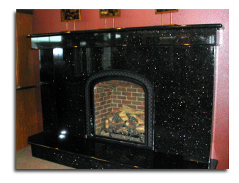 Fireplace mantel, hearth, and surround in Black Galaxy granite